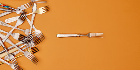 Cutlery. Flat lay photo of variety of antique silverware and gold kitchen forks arranged against studio background. Concept of food, holiday, table setting, retro, vintage. copy space. adの写真素材
