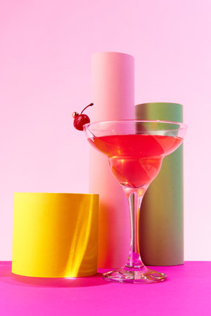 Poster. Delicious margarita cocktail, invitingly decorated with cherry standing on podium against vivid colorful background. Concept of party, drinks, alcohol, celebration, holiday. Adの写真素材
