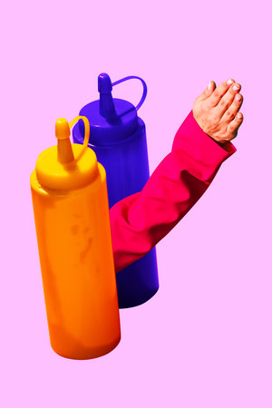 Female hand picking out two bottles with sauces. Mustard, ketchup, mayonnaise on pink background....