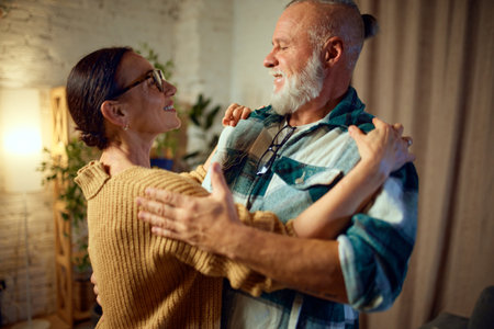 Active seniors. Happy mature couple dancing of happiness, joyful while spending time together and...