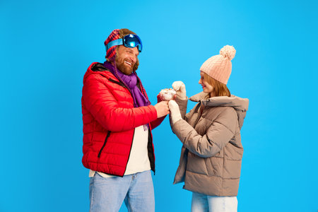 Father and daughter on winter vacation. Smiling dad share ice cream funny cute teenager eating sweet...