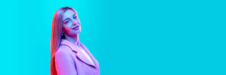 Banner. Side view close up portrait of young beautiful businesswoman looks at camera against gradient pink studio background in neon light, filter. Concept of energy, fashion, style, business.の写真素材