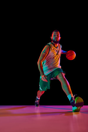 Intense concentration of basketball player during training session, emphasizing commitment to...