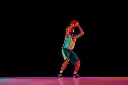 Full length portrait of basketball player workout in motion, highlighting dedication to perfecting...