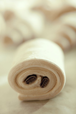 Close up shot of pain au chocolat. Pastry similar to a croissant but with a bar of chocolate baked...