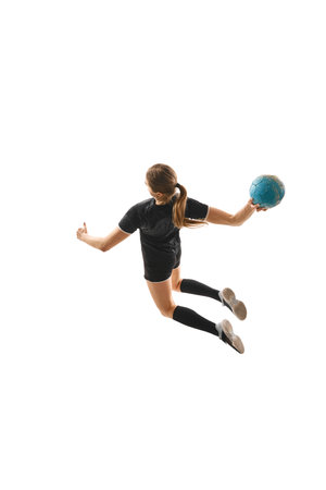 Top view portrait of skilled female handball player in motion, executing powerful throw with determination against white background. Concept of professional sport, movement, dynamic, championship.の写真素材