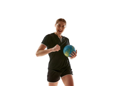 Young woman, professional handball athlete happy because she scored perfect decisive goal against opponent against white background. Concept of professional sport, championship 2024, victory, winner.の写真素材