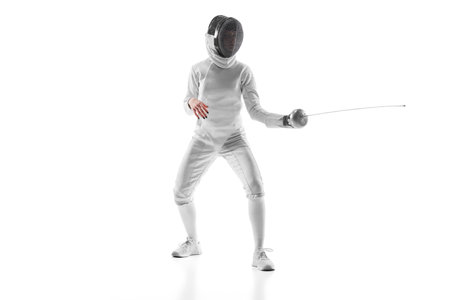 Female fencer intense gaze as she anticipates her opponents move, tension palpable against white...