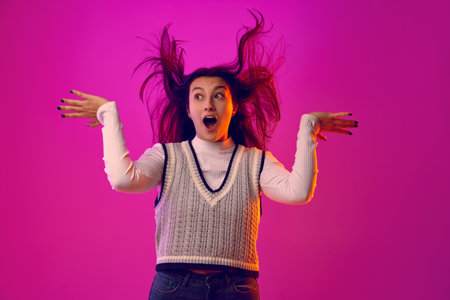 Dynamic portrait of girl to open her eyes and mouth wide, creating moment of uninhibited emotion against pink gradient background. Concept of human emotions, beauty and fashion, media. Adの写真素材