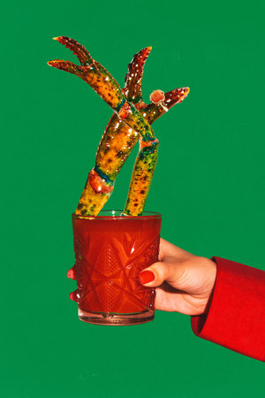 Contemporary art collage. woman, sitting at festive bar, holds aloft Bloody Mary and decorated with miniature lobster. Concept of party, surreal, lifestyle, nightclub, Friday moodの写真素材