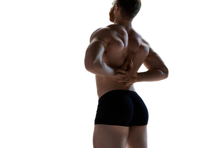 Rear view photo of young, athlete naked man demonstrated his perfect and healthy back shape against...