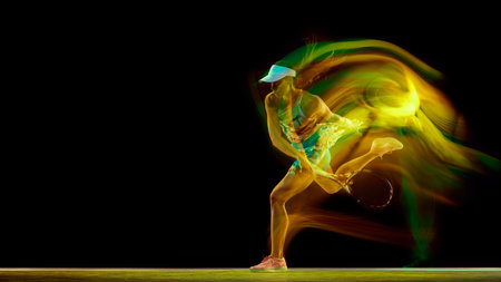 Dynamic photo of young woman, tennis player playing in motion with colorful motion blur against black studio background. Concept of women in sport, active lifestyles, tournaments and events, movement.の写真素材