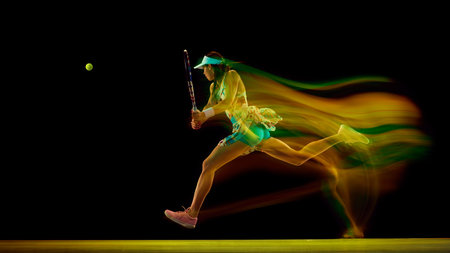 Focused athlete in tennis gear executing powerful forehand swing with colorful motion blur against...