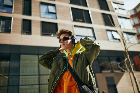 Cool attitude young guy, in overcited bright clothes, reflecting essence of modern street style...
