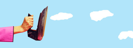 Banner. Contemporary art collage. Arm in a pink jacket ironing blue sky with fluffy white clouds. Dreamy mood. Concept of summertime, holidays, vacation, party, fashion and style.の写真素材