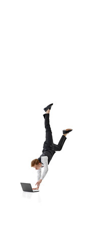 Banner. Businessman in formal attire skillfully balances on one hand while using laptop against white background. Copy space. Concept of business, work and study, hobby, freelance, office. Adの写真素材