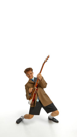Poster. Young talented man dressed vintage attire performing with guitar against white studio background. Copy space. Concept of music, festivals, contemporary art, hobby, creativity. Adの写真素材