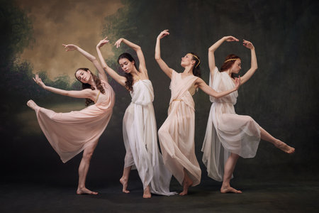 Serene Ballet. Ethereal ballerinas dancers posing in floating beige dress against vintage studio background. Concept of ballet, history and classic, fusion of modernity and ancient times in art.の写真素材