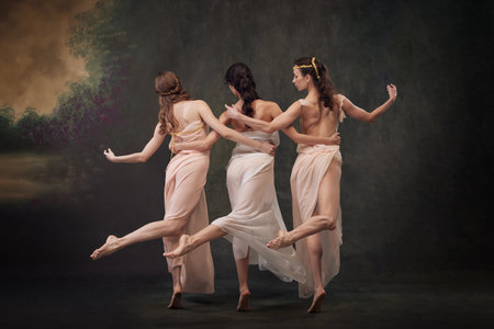Poetry ballet. Rear view photo of charming, graceful girls dancing against vintage studio background. Concept of ballet, history and classic, fusion of modernity and ancient times in art.の写真素材