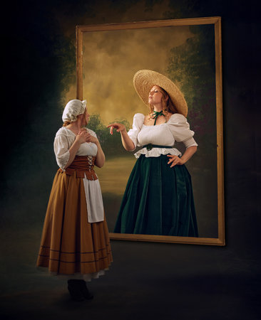 Two women in historical attire, one in bonnet and white blouse, other in straw hat and green skirt, interact through large, frame set against vintage textured background. Comparing lifeの写真素材