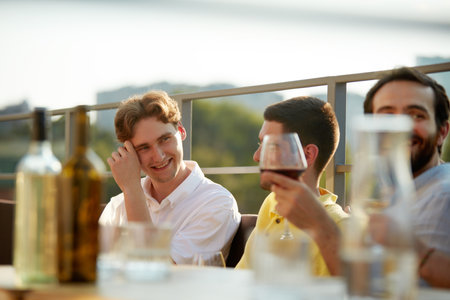 Portrait of happy group of friends raises their glasses in toast, celebrating together bright sunny day. Concept of party, Friday mood, celebration, summer holidays, relax.の写真素材