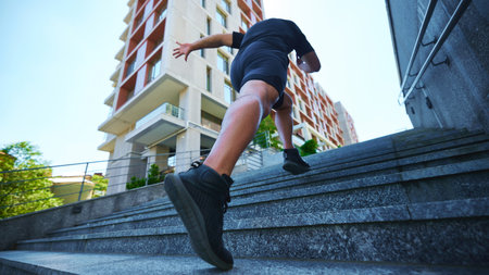 Low angle view of intense workout scene, focusing on close-up of mans colorful running shoes as she...