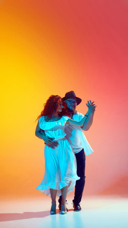 Practicing salsa with enthusiasm, this pair sharpens their skills in neon light against gradient...