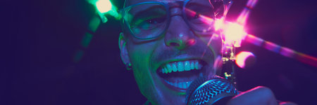 Banner. Power of live music captured in singers face, highlighted by dynamic neon lights as pour his heart into mic. Concept of music and party, hobby and work, energy, music festivals. Adの写真素材