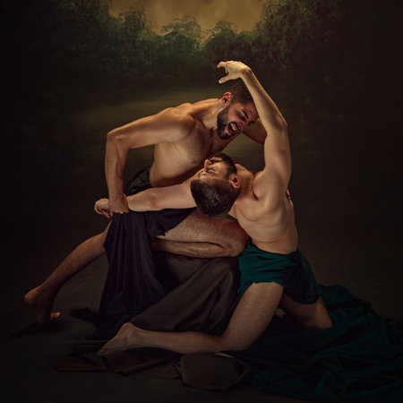 Two demons engage in fierce, intense struggle, capturing raw power and chaos inherent within dark forces. Bible motives. Concept of classic art, renaissance, light and dark.の写真素材
