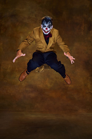 Sinister clown mid-air, eyes wide and arms outstretched, as if leaping toward his next victim...