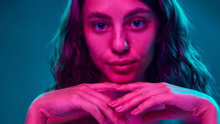 Serene yet intense look, where vibrant colors highlight facial features and smooth skin, merging...