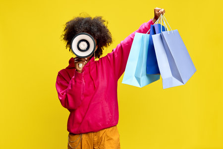 Bright shopping bags in hand and megaphone in other, energetic figure announces sale season with...