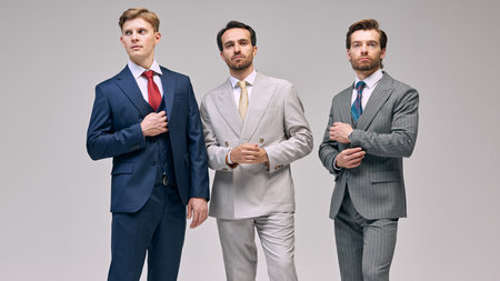 Stylish portrait of young men, posing, showing preparation and readiness for meetings against white studio background. Concept of male fashion, style, beauty, aesthetic. Adの写真素材