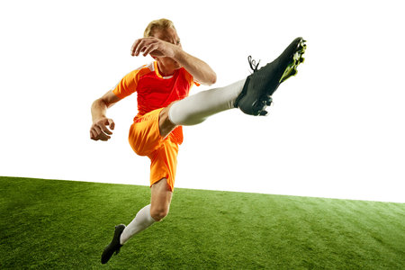 Footballer delivers high kick, with perfect technique and focus on ball. His posture highlights balance and precision needed for such move. Concept of competition, sport games, movement, energy. Ad.の写真素材