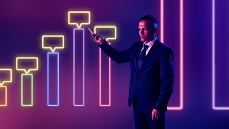 Young businessman, corporate presenter elaborates on data trends, using interactive visuals as...