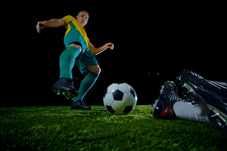 Close-up of soccer ball with two players converging in dynamic moment on field. Bombardier opponent of goalkeeper. Concept of sport event, championship, motion, match, energetic game. Adの写真素材