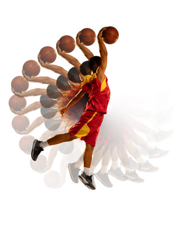 Dynamic photo of basketball player in red and yellow uniform performing powerful dunk. Stroboscope effect highlights actions intensity. Concept of sport in motion, development of movement, training.の写真素材