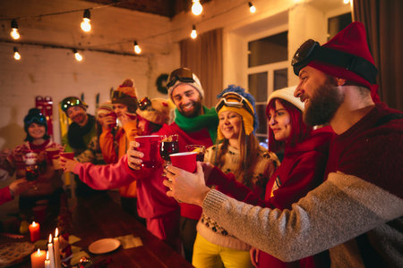 Holiday celebration unfolds as cheerful group of friends clinks glasses around candlelit table...