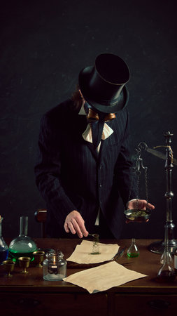 Portrait of meticulous plague doctor in action, carefully weighing substances in vintage laboratory against dark mystery background. Concept of comparisons of eras, medicine, science, pharmaceutical.の写真素材