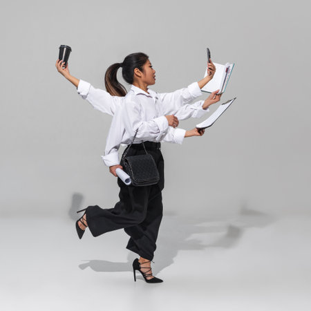 Fast-paced, high-energy environment of modern business culture. Woman runs with coffee, clipboard, phone, and documents. Concept of business, professionalism, multitasking. Adの写真素材