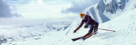 Skier making sharp turn on snowy mountain slope, scattering snow, with dramatic clouds and expansive...