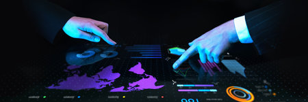 Business professionals collaborating over interactive digital table with global financial data,...