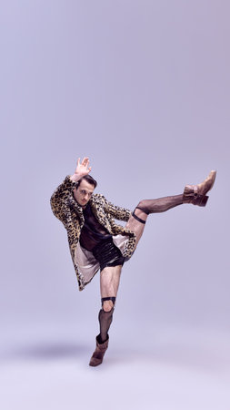 Confident man in mid-motion with bold outfit, in expressive pose, with strong gaze against stylish backdrop. Concept of beauty and fashion, avant-garde, fearless self-expression, modern aesthetics.の写真素材