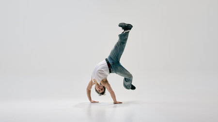 Expressive movement artist stands on hands, pushing physical limits through freestyle dance energy...