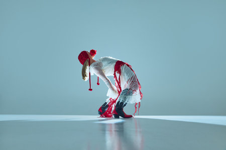 Young woman in white lace dress, red tights, and bonnet bends backward in surreal pose, symbolizing...