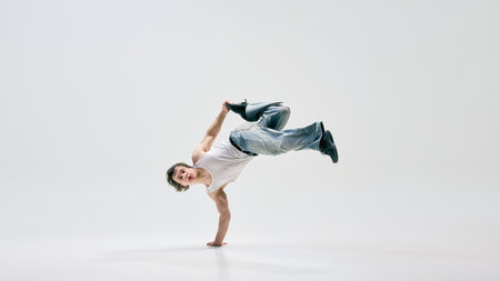 Skilled b-boy, dressed casually, executing powerful aerial move, seamlessly merging art and sport...