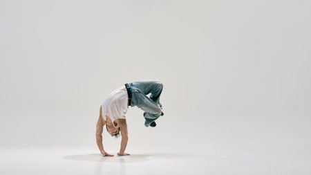 Passionate b-boy, dressed retro attire, holding challenging freeze, showcasing art and balance...