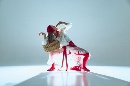Woman twisting in fluid motion, lace dress swirling, gaze piercing, symbolizing subconscious expression, breaking free from constraints. Concept of dynamic fashion, avant-garde photography.の写真素材