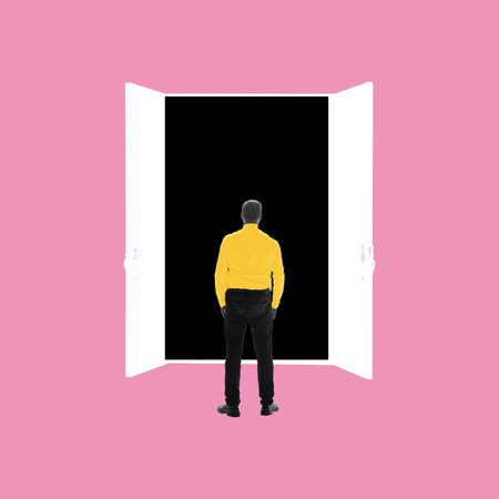 Conceptual design. Man stands in front of open white door leading into darkness symbolizing fear of job market unknown. Concept of crisis, depression, jobloss, human resources, recruitmentの写真素材