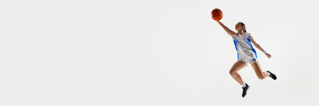 Banner. Focused on game teen girl performing perfect block in mid air jump against white background with negative space to insert text. Concept of professional sport, woman in sport, movement. Adの写真素材